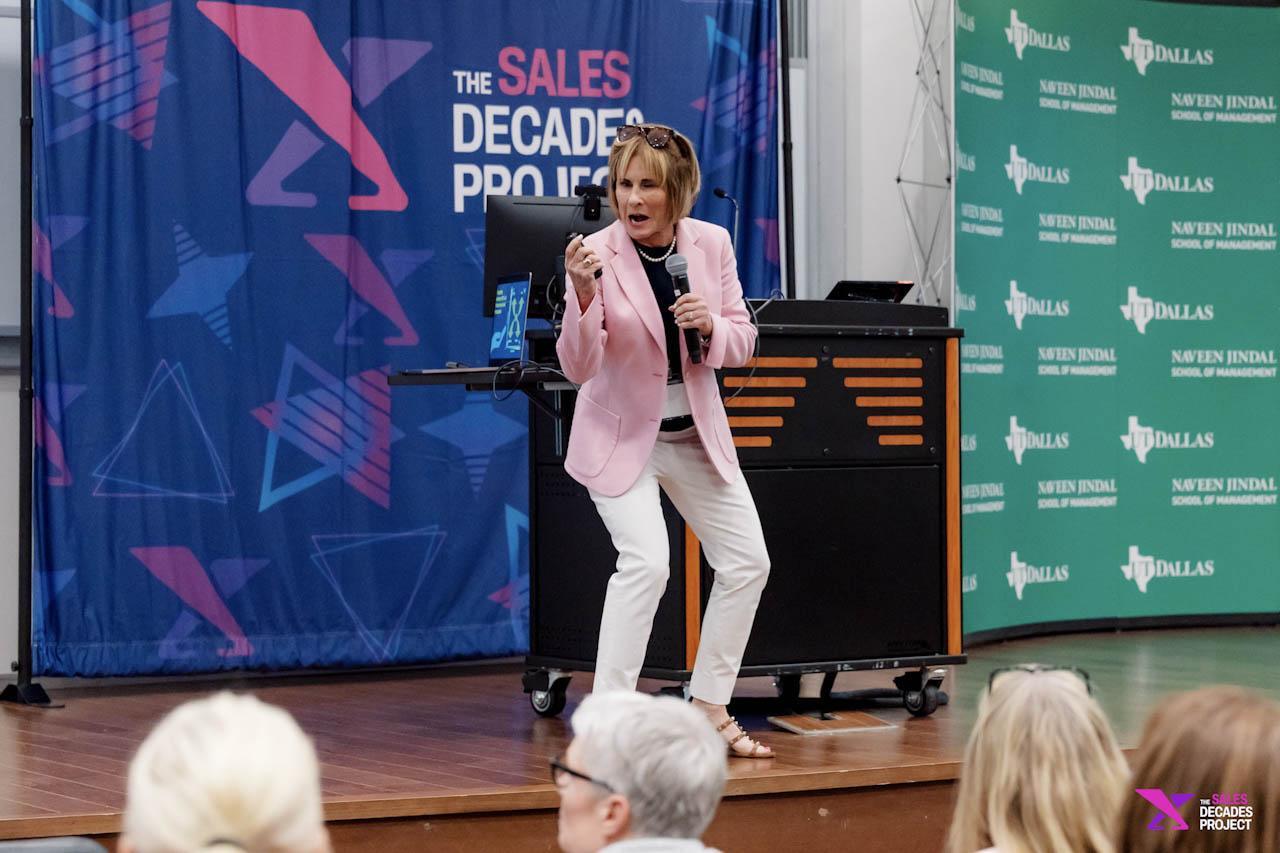 Speaker presenting on stage at UT Dallas